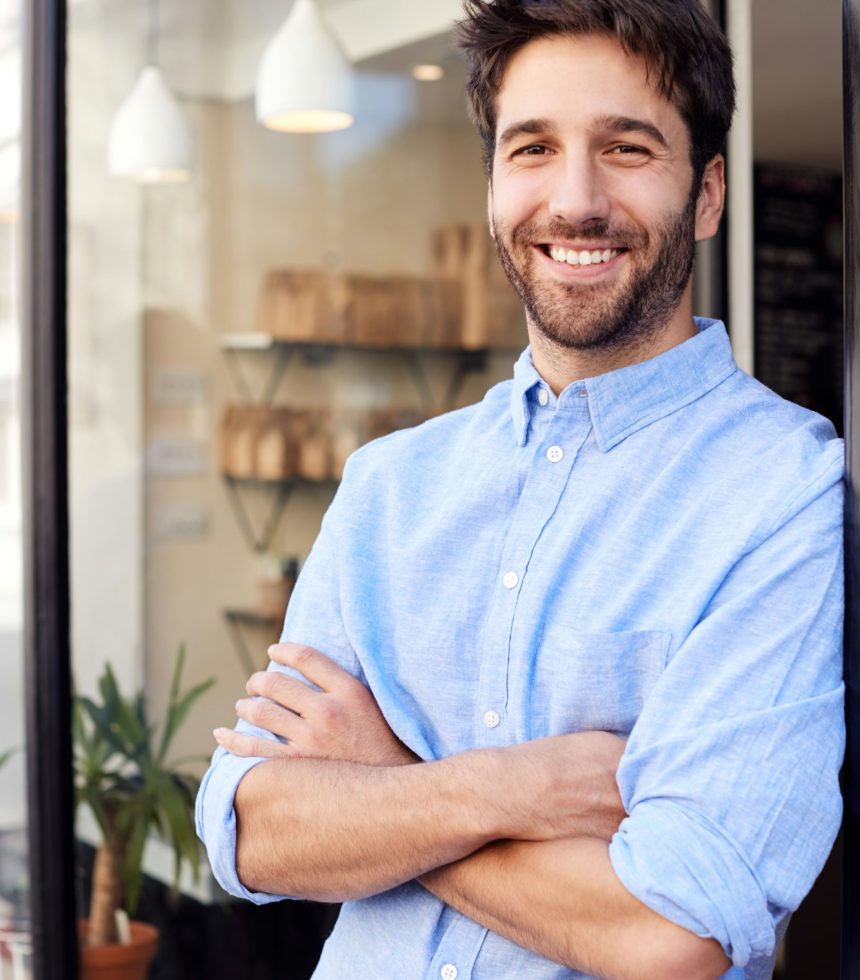 Portrait Of Male Owner Standing Outside Coffee Shop